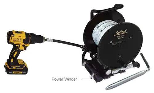solinst power winder installed onto tag line using flexible adaptor connected to a cordless power driller for easy deployment of sand and bentonite layers in wells and boreholes
